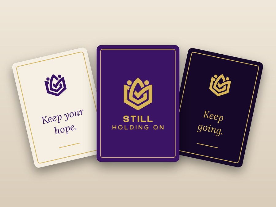 Inspirational cards printed with the Still Holding On logo and short messages of hope