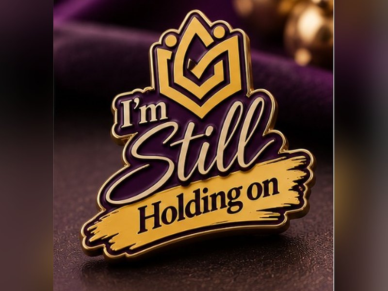 Gold enamel lapel pin reading I'm Still Holding on, with the Still Holding On emblem